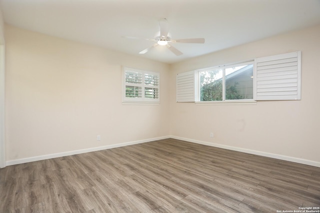 empty room featuring baseboards, a ceiling fan, and wood finished floors