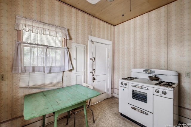 kitchen with wooden ceiling, wallpapered walls, and double oven range