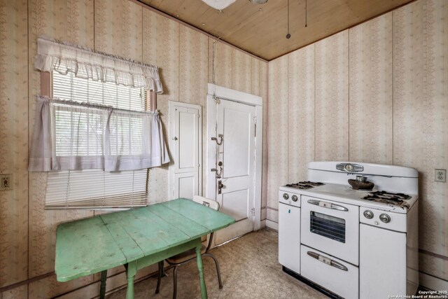 3403 W Travis, San Antonio, TX 78207 - kitchen with wooden ceiling, wallpapered walls, and double oven range