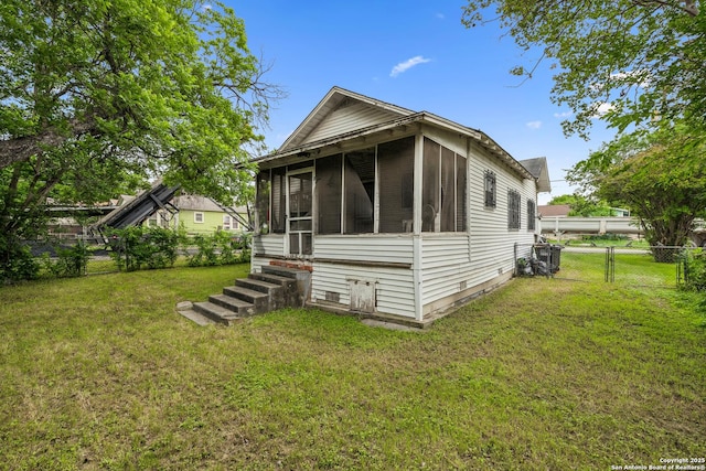 3403 W Travis, San Antonio, TX 78207 - view of front facade featuring a front yard, fence, a gate, and a sunroom