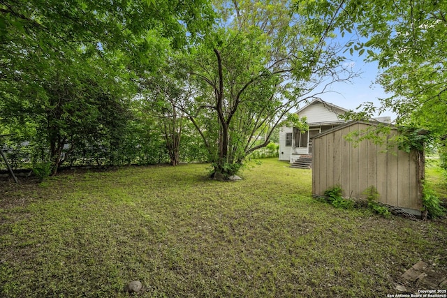 view of yard with an outdoor structure and a shed