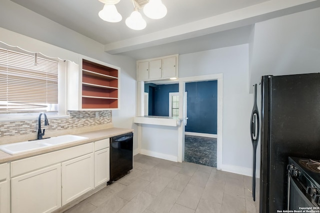 kitchen featuring a sink, light countertops, a chandelier, tasteful backsplash, and black appliances
