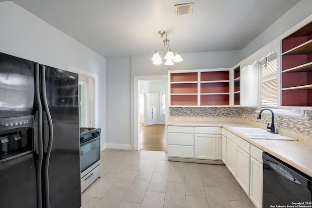 kitchen with a sink, open shelves, black appliances, and backsplash