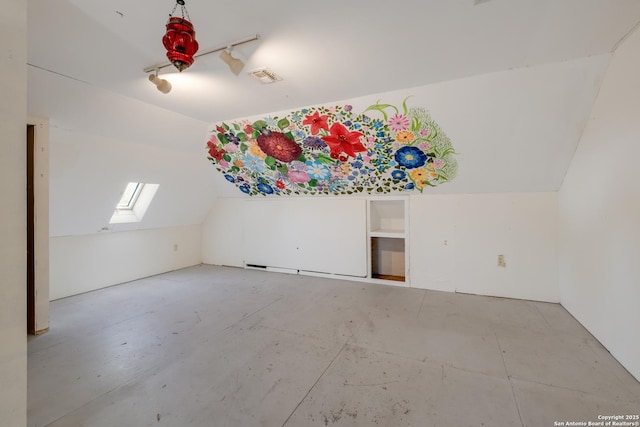 additional living space featuring visible vents and lofted ceiling with skylight