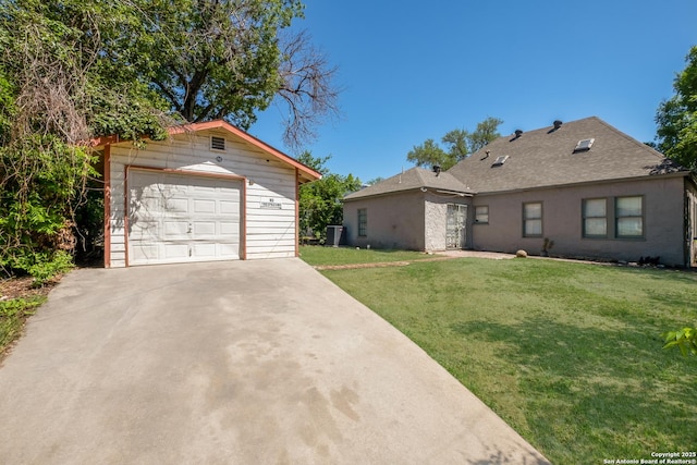 1303 Hicks Ave, San Antonio, TX 78210 - single story home with a detached garage, central AC, concrete driveway, an outbuilding, and a front lawn