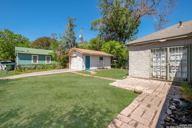 1303 Hicks Ave, San Antonio, TX 78210 - view of yard with a detached garage, an outbuilding, and driveway