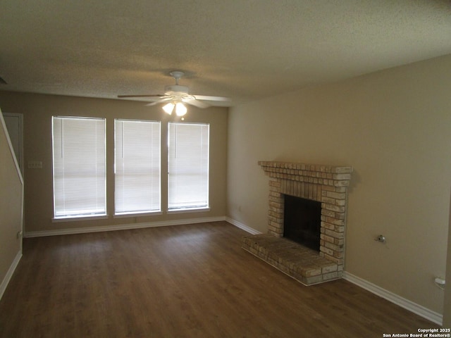 unfurnished living room with a ceiling fan, a textured ceiling, a fireplace, wood finished floors, and baseboards
