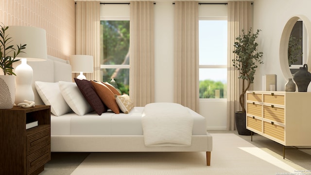 bedroom with baseboards and light carpet