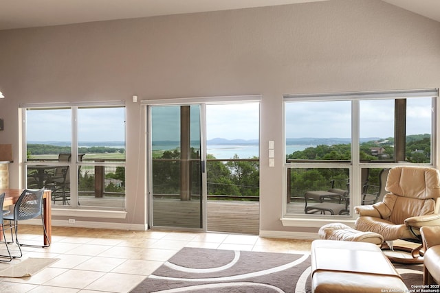 interior space with baseboards, light tile patterned floors, and a healthy amount of sunlight