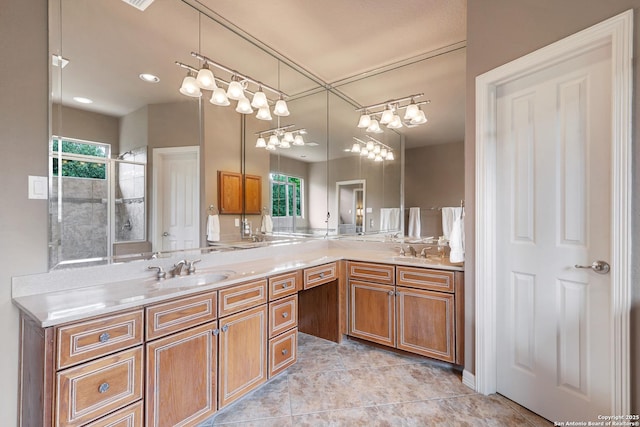 bathroom featuring a sink, double vanity, and a wealth of natural light