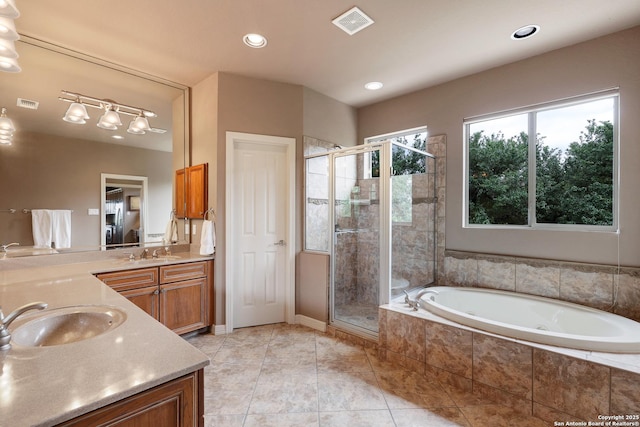 full bath with double vanity, a sink, a bath, and a stall shower