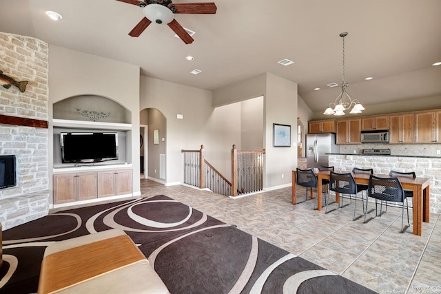 living room with built in features, ceiling fan with notable chandelier, recessed lighting, baseboards, and light tile patterned floors