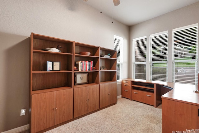 unfurnished office featuring ceiling fan, light carpet, and baseboards