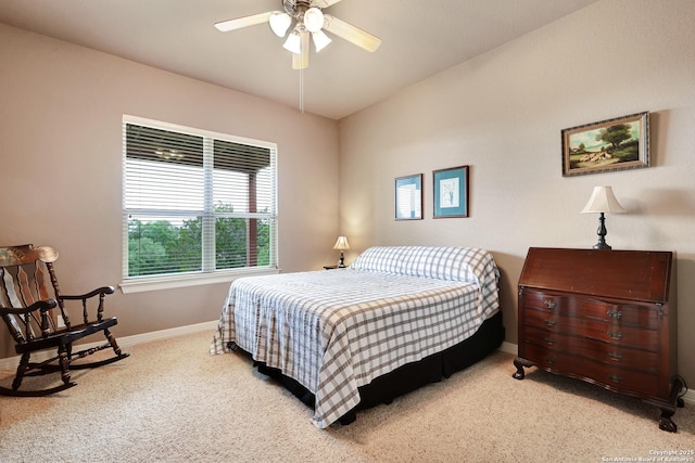 carpeted bedroom featuring baseboards and ceiling fan