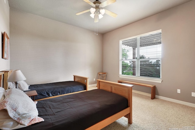 carpeted bedroom featuring baseboards and a ceiling fan