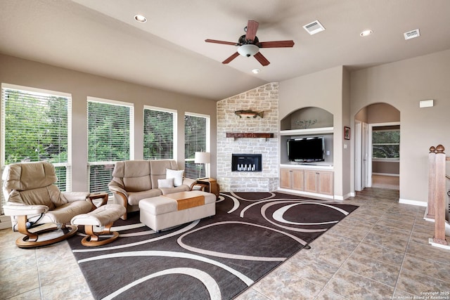 living area featuring ceiling fan, vaulted ceiling, built in shelves, and visible vents