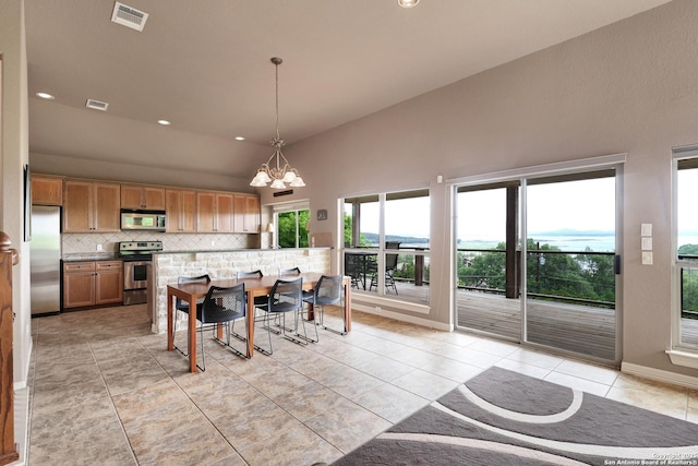 dining space with light tile patterned floors, high vaulted ceiling, visible vents, and a chandelier
