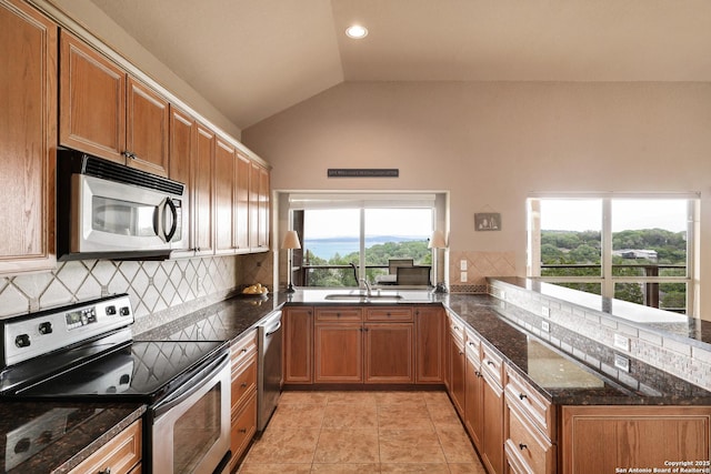 1298 Oakridge Ln, Canyon Lake, TX 78133 - kitchen with a sink, appliances with stainless steel finishes, vaulted ceiling, and tasteful backsplash