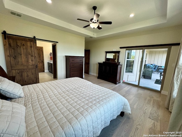 120 Sam Houston, Kerrville, TX 78028 - bedroom featuring light wood-style floors, a barn door, access to exterior, recessed lighting, and baseboards