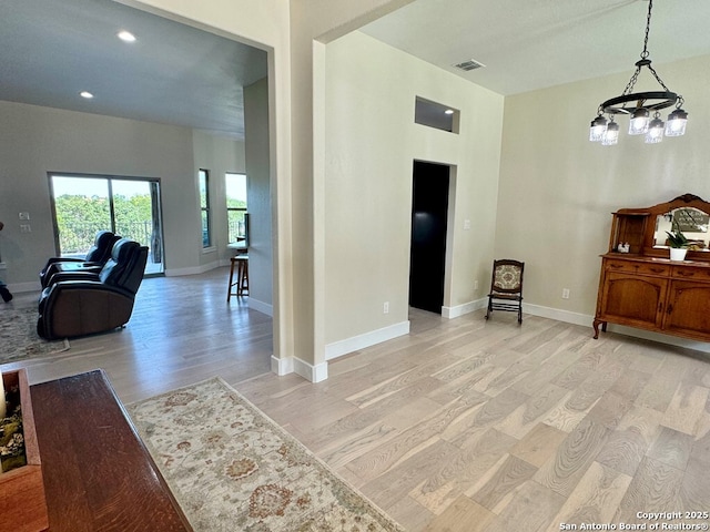 120 Sam Houston, Kerrville, TX 78028 - entrance foyer with light wood finished floors, a chandelier, baseboards, and recessed lighting
