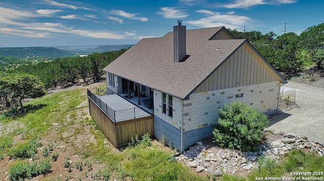 120 Sam Houston, Kerrville, TX 78028 - rear view of house with board and batten siding, a shingled roof, and a chimney