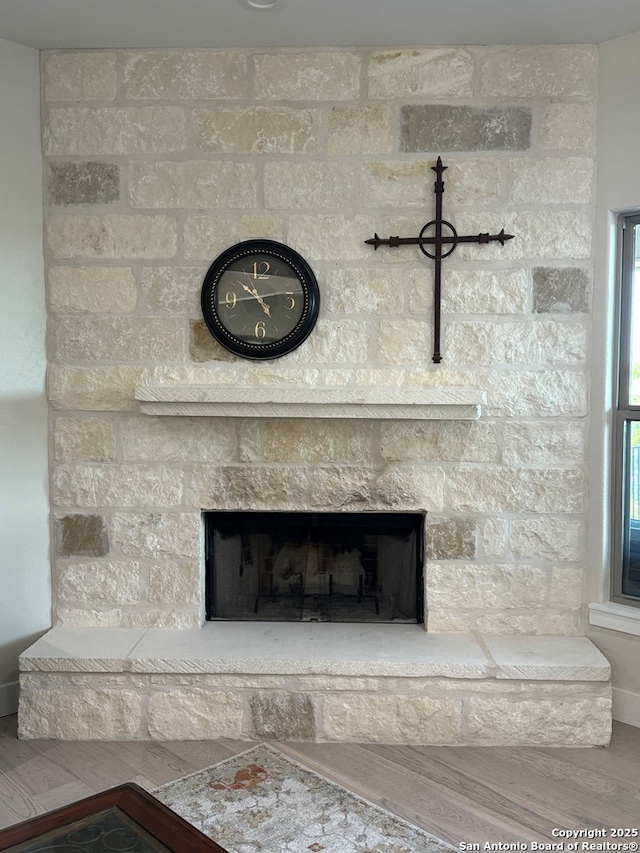 120 Sam Houston, Kerrville, TX 78028 - detailed view of a fireplace, wood finished floors, and baseboards