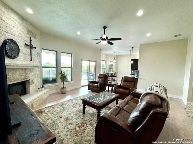 120 Sam Houston, Kerrville, TX 78028 - living room featuring recessed lighting, ceiling fan, baseboards, a fireplace, and wood finished floors