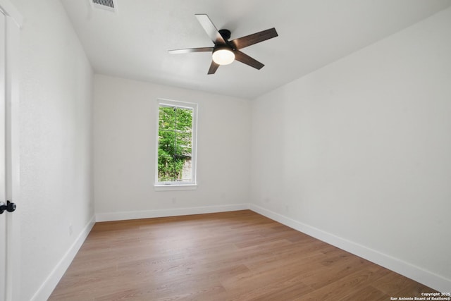 unfurnished room with light wood-type flooring, baseboards, ceiling fan, and visible vents