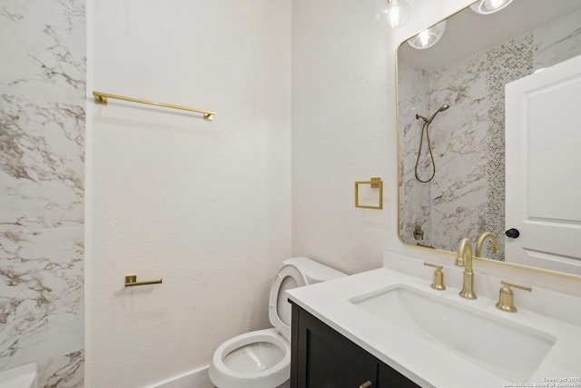 bathroom with vanity, marble finish floor, walk in shower, and toilet