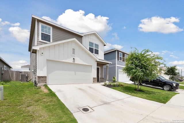 view of front of house with board and batten siding, fence, driveway, and a front yard