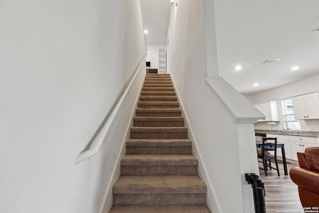 stairs featuring recessed lighting, baseboards, and visible vents
