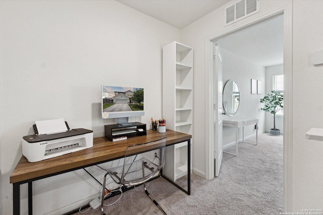 carpeted office space with baseboards and visible vents