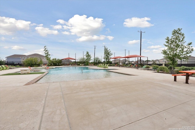community pool featuring a patio area and fence