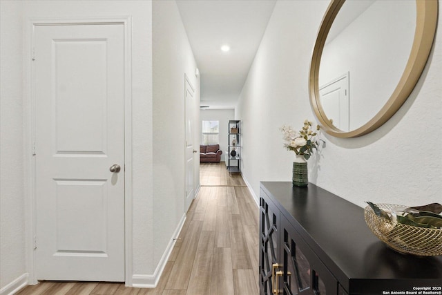 hallway with recessed lighting, baseboards, and light wood-style floors