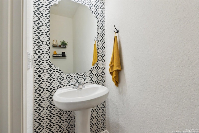 bathroom with a textured wall