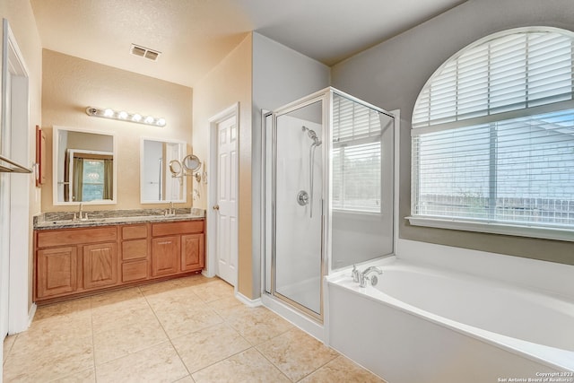 full bath featuring a sink, tile patterned flooring, a shower stall, visible vents, and a bath