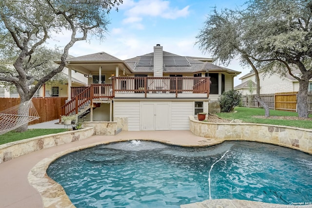 3234 Bending Crk, San Antonio, TX 78261 - rear view of house featuring stairs, a wooden deck, a fenced backyard, a chimney, and solar panels
