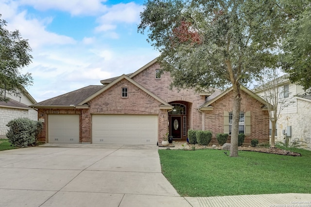 view of front of property featuring roof with shingles, brick siding, a garage, a front yard, and driveway
