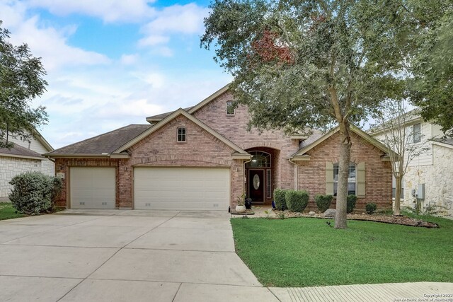 3234 Bending Crk, San Antonio, TX 78261 - view of front of property featuring roof with shingles, brick siding, a garage, a front yard, and driveway