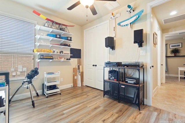 interior space with ceiling fan and visible vents