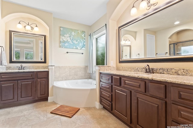 bathroom with a sink, a bath, two vanities, and a shower stall