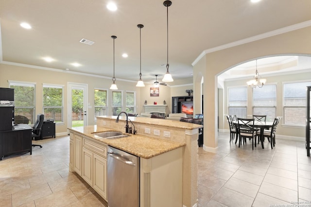 kitchen with visible vents, a fireplace, cream cabinets, a sink, and dishwasher