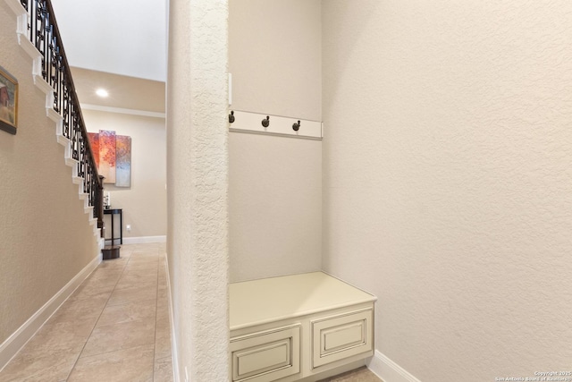 mudroom featuring baseboards, a textured wall, recessed lighting, and light tile patterned flooring