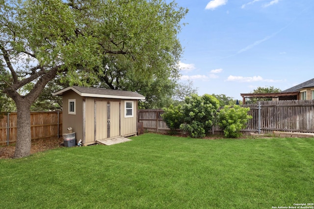 view of yard with a fenced backyard, an outbuilding, and a storage shed