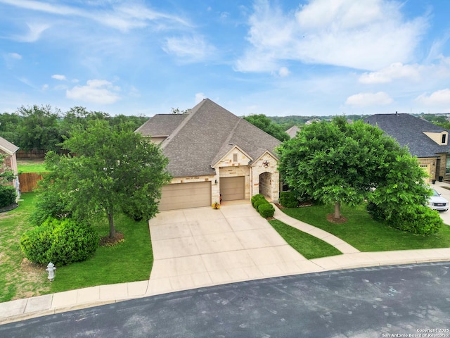 french country home featuring concrete driveway, roof with shingles, and a front yard