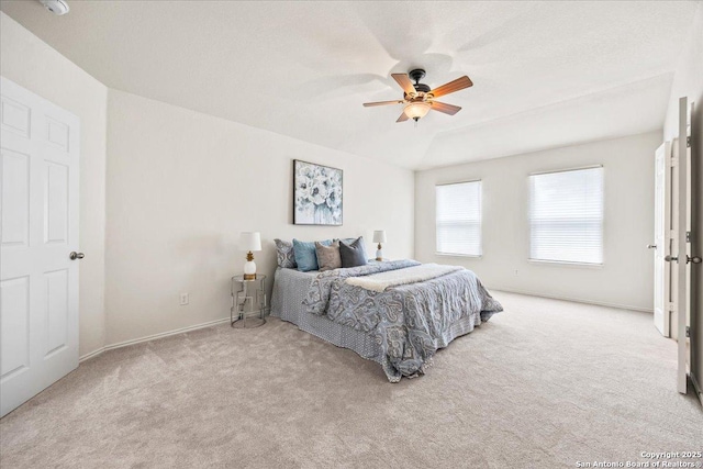 carpeted bedroom featuring baseboards and ceiling fan
