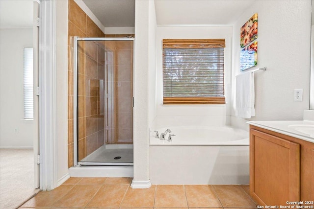 bathroom with vanity, a stall shower, tile patterned floors, and a garden tub