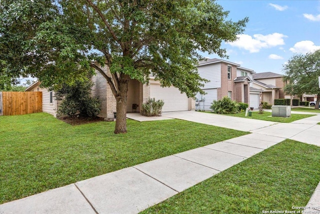view of front of property featuring fence, an attached garage, concrete driveway, and a front yard