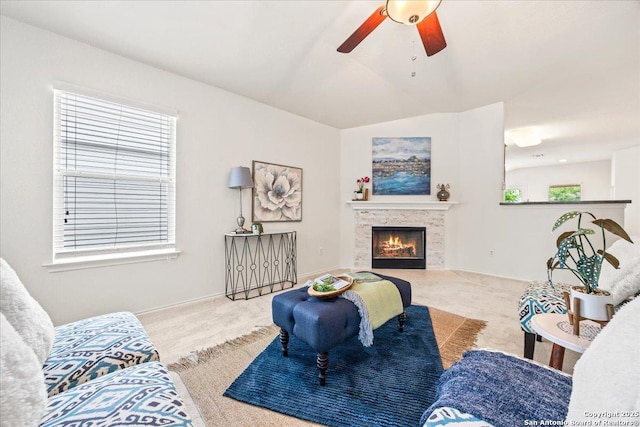 carpeted living room with a ceiling fan and a fireplace