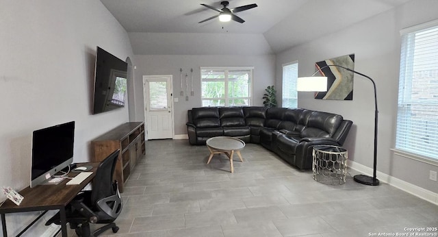 living area featuring a ceiling fan, baseboards, and lofted ceiling
